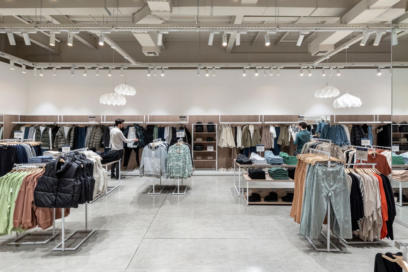 BAS Store - Wide shopping aisle featuring denim displays and neutral color palette - Contract Workplaces.jpg